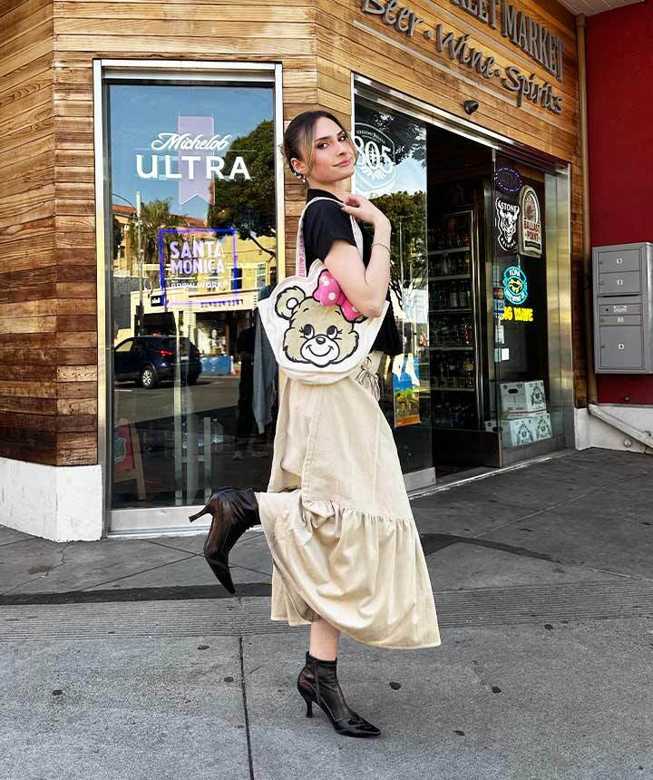 model posing behind a store 